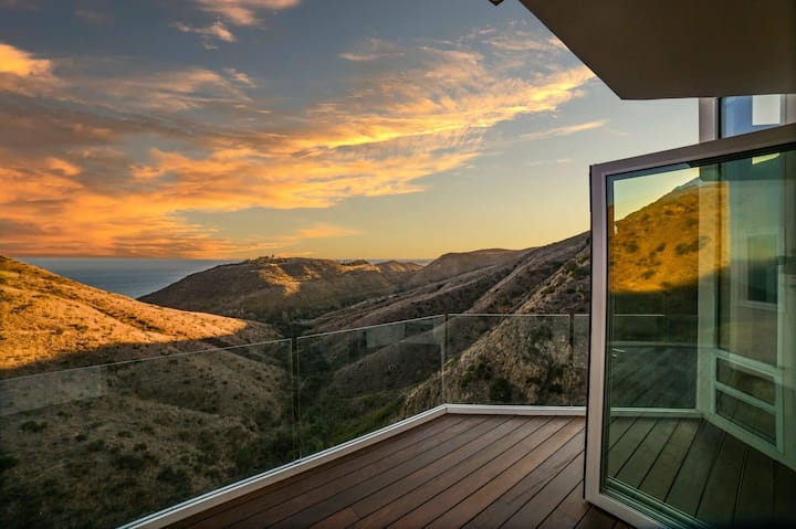 Main living room with glass walls and ocean view
